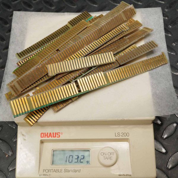 Lot of used gold-finger PCB edge connectors weighed at 103.2g on Ohaus LS 200 scale. Gold contacts show patina and oxidation on green FR4 substrate.