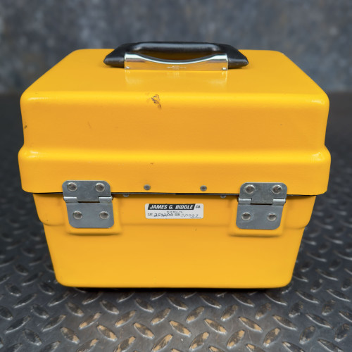 Rear view of the closed yellow case of the Biddle Megger Digital Ground Earth Tester from Obtainium Science and Surplus, showing the James G. Biddle Co. label.