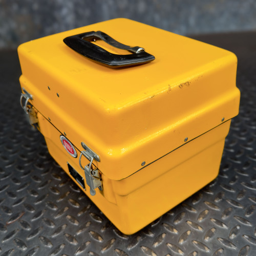 Closed yellow case of the Biddle Megger Digital Ground Earth Tester from Obtainium Science and Surplus, with a black handle on top.