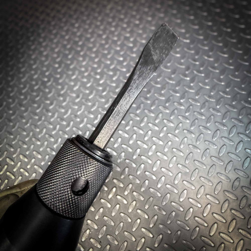 A close-up of the chisel tip and textured grip of the Ingersoll Rand 180PG Pistol Grip Chisel Scaler, with the diamond-plate background visible.