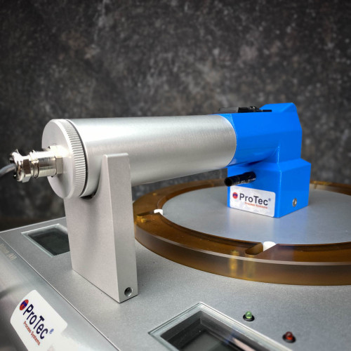 Side view of the blue and silver wafer handling racket on the ProTec electrostatic wafer chuck/de-chuck unit from Obtainium Science Surplus, focusing on the device's mount and the orange circular platform.