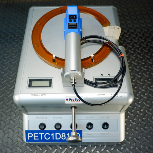 Top view of a ProTec electrostatic wafer handling chuck racket featuring a silver and blue wafer handling racket centered on a metal platform, with control buttons labeled de-chucking, chucking, contact, vacuum, and purge.