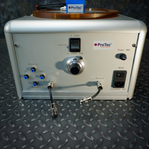 Rear view of the ProTec electrostatic wafer handling chuck racket, displaying various connection ports labeled external, N2, VAC, exhaust, and a main power switch, fuse, and a knob.