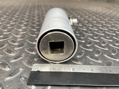 Horizontal view of the Norbar Torque Transducer, with the square 3/4" drive end facing forward. A ruler lies beside it for size reference, and the metallic surface creates a repeating diamond pattern underneath.