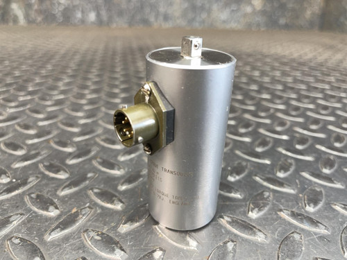 A Norbar 5000-2ETS Torque Transducer – 50 LBF·IN, 1/4" Drive from Obtainium Science and Surplus, standing upright on a textured metal surface, with a circular top component and a side electrical connector.