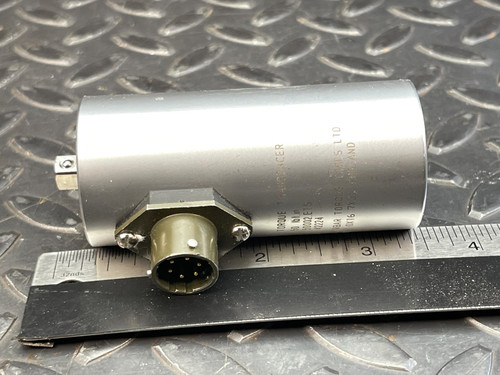 Horizontal view of the Norbar 5000-2ETS Torque Transducer – 50 LBF·IN, 1/4" Drive from Obtainium Science and Surplus, with the cylindrical body resting on a textured surface and its connector port facing outward.