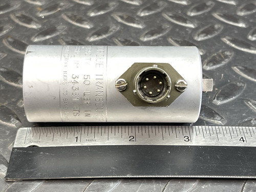 Side view of the Norbar Torque Transducer, displaying a circular connector on its side and a ruler beneath it for measurement.