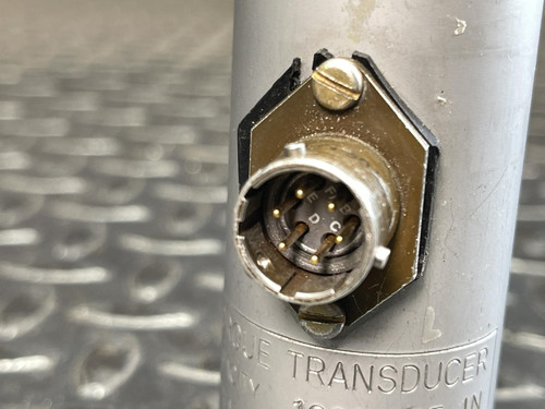 Close-up shot focusing on the transducer's metal connector with multiple pins inside, attached to the side of the cylindrical body.