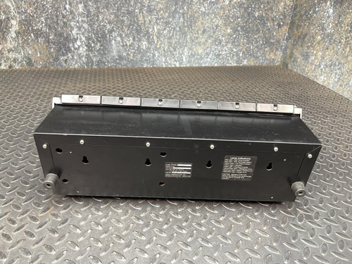 Bottom view of the Thales battery charger for MBITR tactical radios from Obtainium Science Surplus, showing labels and information stickers.
