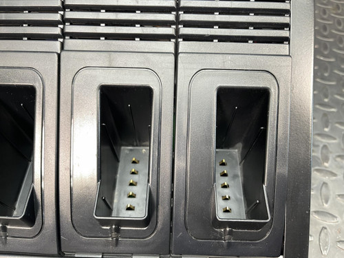 Close-up view of the charging slots on a Thales battery charger for MBITR tactical radios.