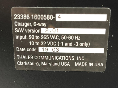 Close-up of the label on a Thales battery charger for MBITR tactical radios, detailing specifications.