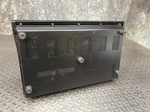 Bottom view of a Thales battery charger for MBITR tactical radios, showing vent and port details.