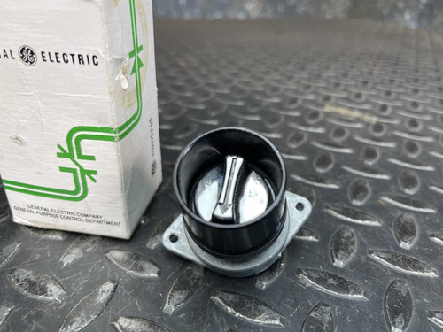 Close-up of the GE 3-Position Oil-Tight Switch - Model CR2940UB200B, highlighting its black rotating knob and metal mounting base next to the original box.