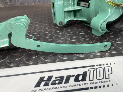 Close-up view of the CS Unitec Pneumatic Chainsaw's handle and attachment parts, highlighting the label 'HardTOP CE Performance Forestry Equipment'.
