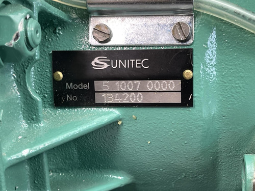 Close-up of the CS Unitec Pneumatic Chainsaw's model and serial number plate from Obtainium Science and Surplus, showing 'UNITEK Model 5 1007 0000 No 134200'.