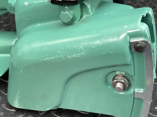 Detailed view of the side of the CS Unitec Pneumatic Chainsaw from Obtainium Science and Surplus, showcasing the bolts and attachment points.