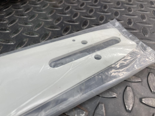 Close-up of the CS Unitec Pneumatic Chainsaw's handle and attachment point, showing a brass connector from Obtainium Science and Surplus.