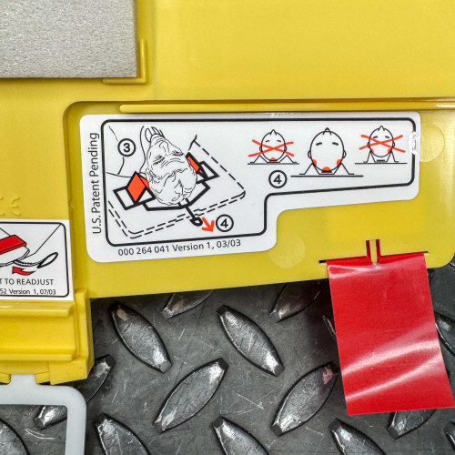 The image displays a further instructional panel on the Ambu Head Wedge cervical immobilization device. It shows detailed diagrams for steps 3 and 4, with illustrations demonstrating how to position and secure the head straps around a patient’s head, ensuring the device's stability. Step 3 illustrates securing the head with red markers indicating proper placement, while step 4 shows incorrect and correct positioning of the head with X and check marks. The panel also includes a note indicating "U.S. Patent Pending" and a reference number, providing context for the device's design and usage regulations.