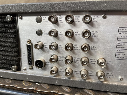 Close-up of the back panel of the Wiltron 6769B Synthesized Sweep Generator from Obtainium Science and Surplus, focusing on labeled ports and warning notices.