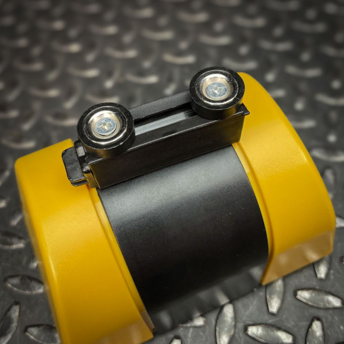 Close-up view of the end magnet mechanism at the front of the Crowd Control Warehouse Magnetic Retractable Belt Barrier from Obtainium Science and Surplus, with two small wheels attached for easy movement.