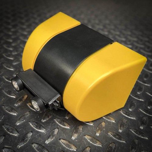 Close-up of the yellow and black housing of the Crowd Control Warehouse Magnetic Retractable Belt Barrier from Obtainium Science and Surplus, showing its compact design and sturdy construction.