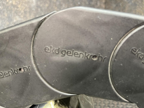 Close-up view of the Nylatube Energy Chain Wireway, highlighting the embossed "ekd gelenkrohr" branding. This product is available from Obtainium Science & Industry Surplus and is shown against a textured metal background.