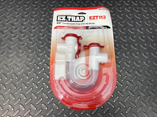 A single package of Rectorseal EZ Trap 3/4" Condensate Trap, EZT113, from Obtainium Science Surplus, placed on a metal surface, showing the front of the packaging.
