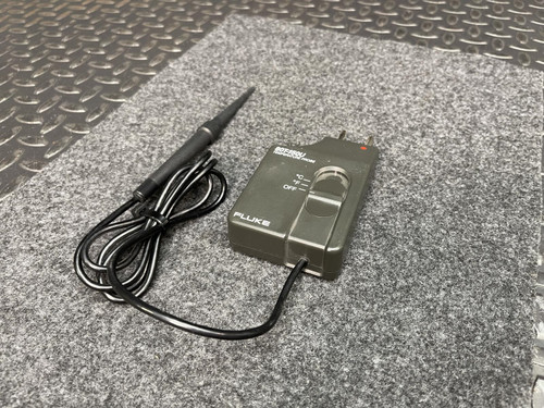 Fluke Temperature Probe from Obtainium Scientific Surplus shown with its probe and main control unit on a gray textured surface.
