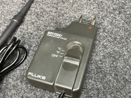 The Fluke Temperature Probe's main control unit from Obtainium Scientific Surplus, displaying its switches and labels on a gray textured surface.