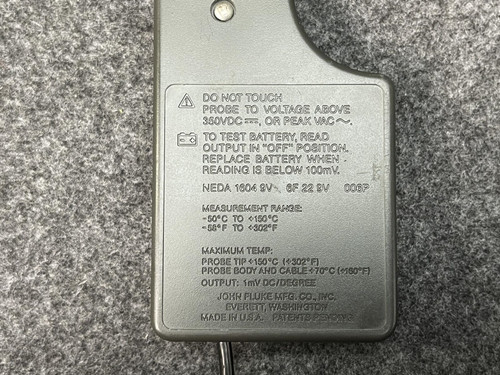 Detailed close-up of the text and warnings on the back of the Fluke Temperature Probe from Obtainium Scientific Surplus on a gray background.