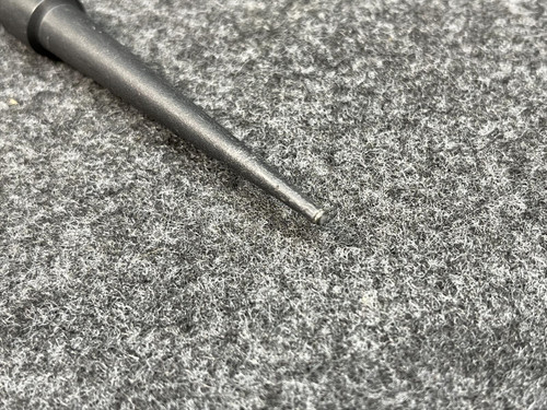 Side view of the Fluke Temperature Probe from Obtainium Scientific Surplus, highlighting the probe handle and coiled black cord on a gray textured surface.