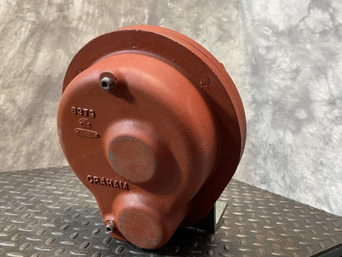 Back view of the Graham heat exchanger from Obtainium Science and Surplus, showing a smooth red casing with rounded features and embossed markings, including “6379” and “Graham,” on a textured metal base.