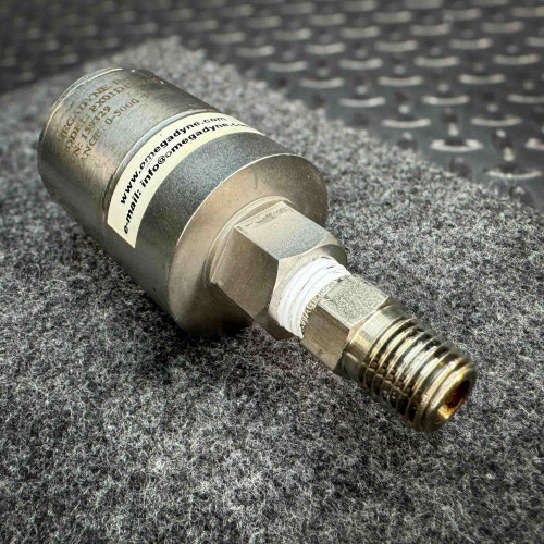 Angled view of an OmegaDyne pressure transducer model PX01D1, displaying its serial number 159329 and a pressure range of 0-5000 PSI. The device has a threaded connection for secure installation and features contact information "www.omegadyne.com" and "info@omegadyne.com." It is placed on a textured surface with a metal background.