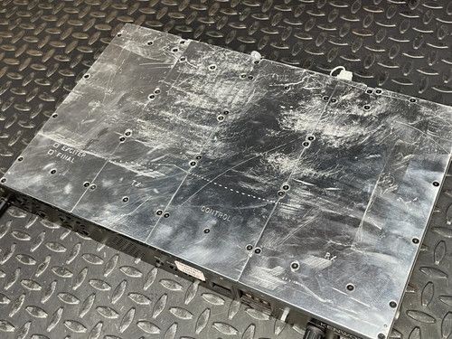 Top view of the Kenwood Radio TKR-840-3 showing the scratched metal surface, placed on a metal grid background.