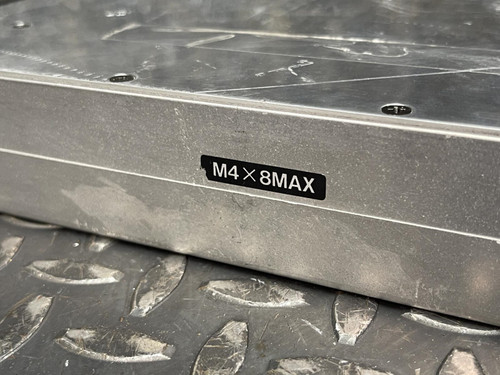 Close-up of the label on the Kenwood Radio TKR-840-3 reading 'M4 x 8 MAX' on a metal grid surface.