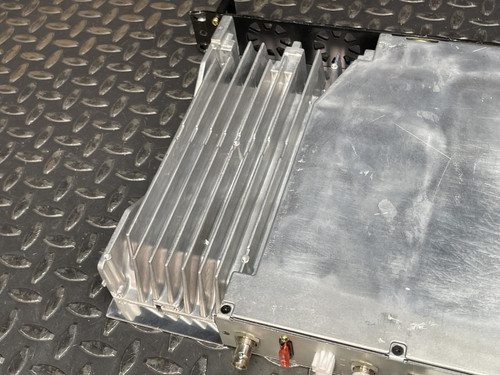 Close-up of the finned heatsink on the rear of the Kenwood Radio TKR-840-3, highlighting the industrial design and worn metal surface.