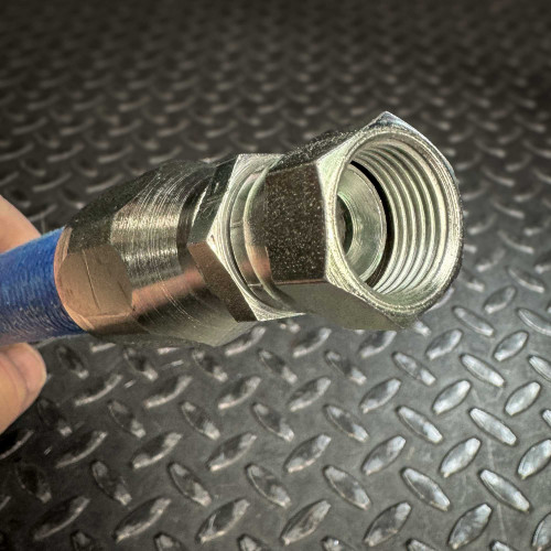 A close-up view of the metal JIC hydraulic fitting on one end of a blue Aeroquip FC300 hose from Obtainium Science and Surplus, showing the inner threading of the connector.