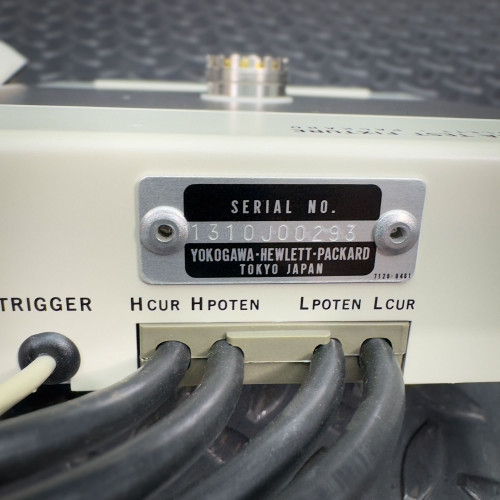 Close-up of the serial number plate on the Hewlett Packard 16021A Test Fixture indicating 'Serial No. 3510A08234' along with other technical details.