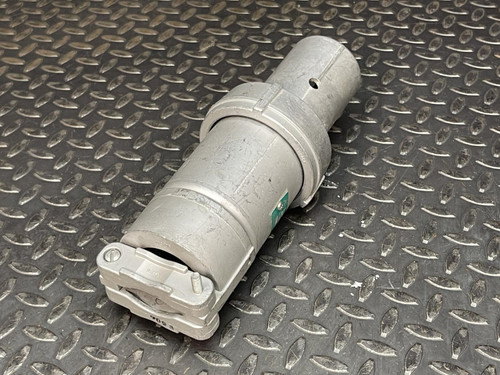 Angled view of an Appleton 100A plug from Obtainium Science and Surplus, showing its cylindrical metallic body and a connector end cap, placed on a metal surface.