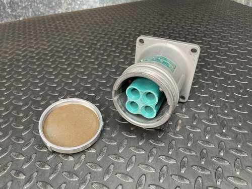 Appleton Powertite ACR1034 pin and sleeve receptacle from Obtainium Science and Industry, shown with its cover removed, displaying four green sockets.