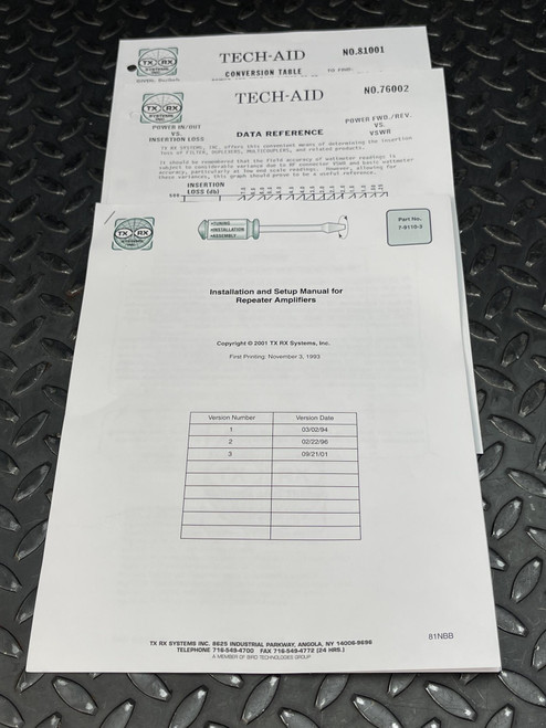 Instruction manual from Obtainium Science and Surplus for the TX RX Systems UHF radiofrequency booster, displayed on a black metal surface.