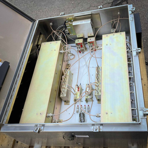 Interior view of a TX RX Systems UHF radio frequency booster from Obtainium Science and Surplus, showing wiring and components neatly arranged inside.