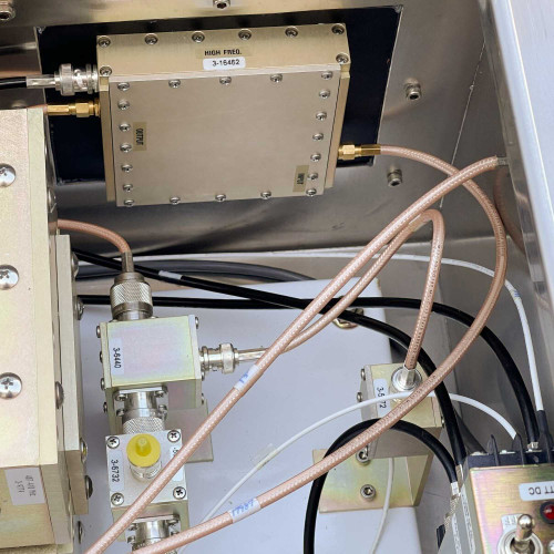 Partial view of the interior of the TX RX Systems UHF radio frequency booster from Obtainium Science and Surplus, showing connected cables and components.