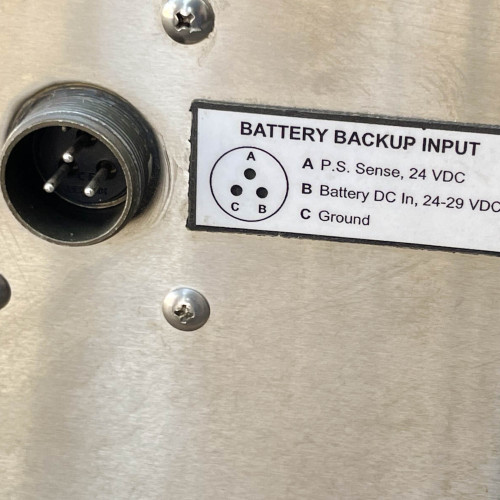 Close-up view of a battery backup input panel on the TX RX Systems UHF radio frequency booster from Obtainium Science and Surplus, showing labeled ports for connections.