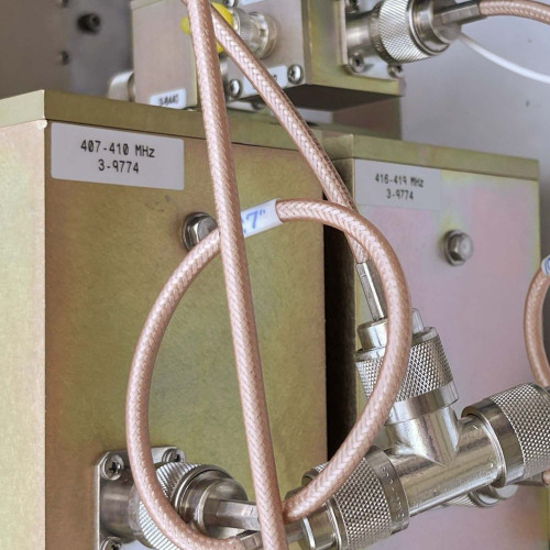 Detailed shot of the wiring and components labeled 407-419 MHz inside the TX RX Systems UHF radio frequency booster from Obtainium Science and Surplus.
