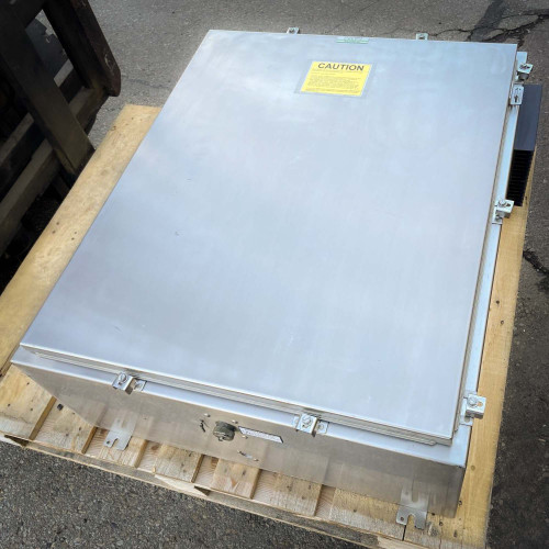 Closed TX RX Systems UHF radio frequency booster from Obtainium Science and Surplus, with a metallic exterior and a yellow warning label on top, placed on a wooden pallet.