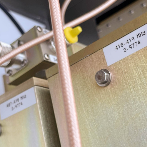Close-up of labeled components inside the TX RX Systems UHF radio frequency booster from Obtainium Science and Surplus, with visible frequency range labels.