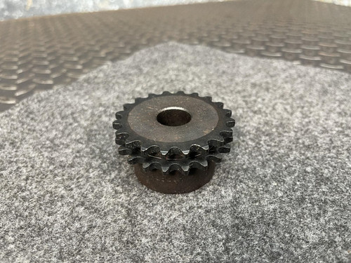 Close-up of the Martin D35B20H double-row sprocket, highlighting its metal teeth and central hole, placed on a gray textured surface.