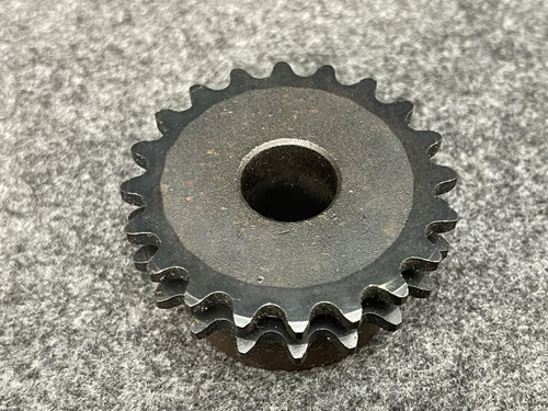 Angled view of the Martin D35B20H double-row sprocket showing both rows of teeth clearly. The gray textured background adds contrast to the dark metal finish.