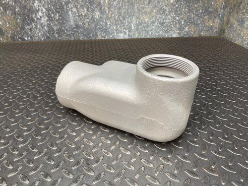 A 3-inch Appleton LL conduit body from Obtainium Science and Surplus, displayed from the side, illustrating the elongated oval shape and textured gray finish.